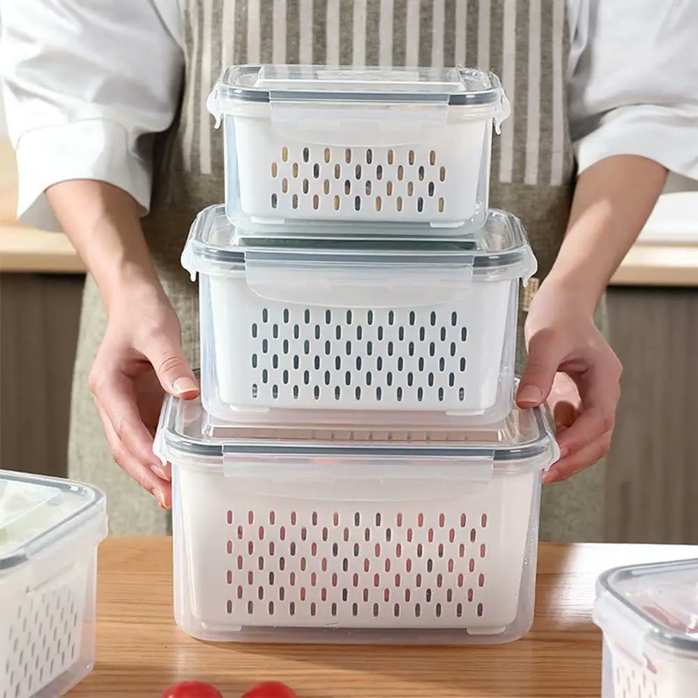 Three sizes held stacked in both hands, the inner basket and the four-clip lid visible on each