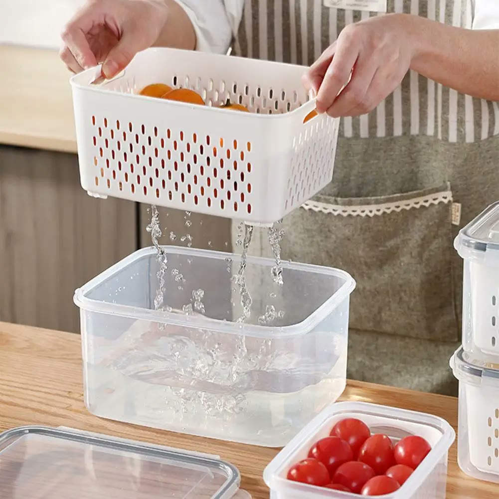 The basket lifted clear of the outer box with rinse water streaming off it into the water already collected below