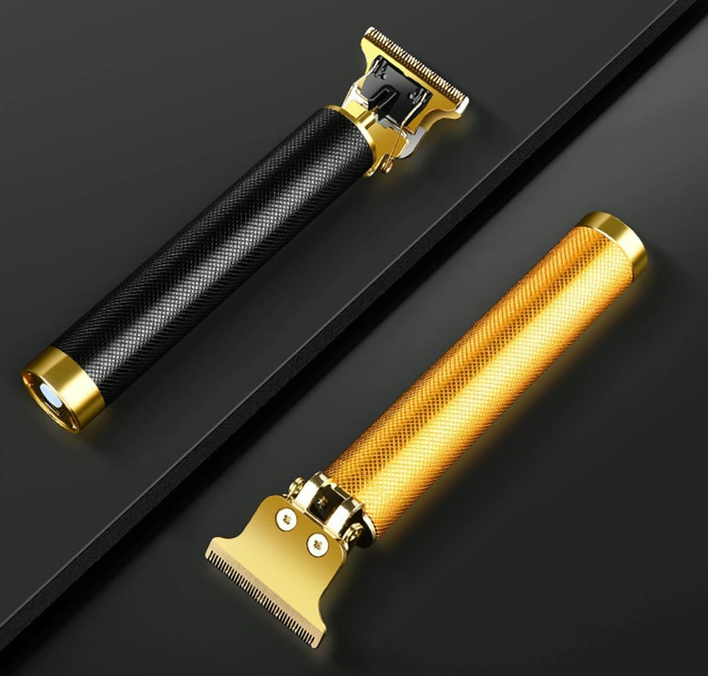 The black and the gold trimmer laid on a dark surface, showing the knurled grip and the gold T-blade